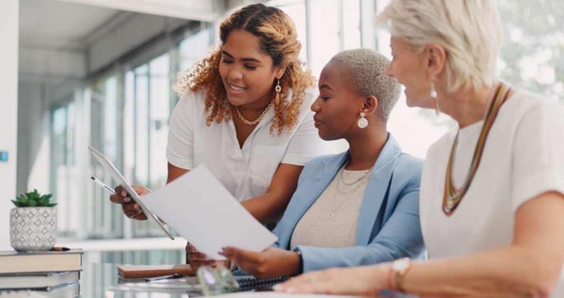 Chart, tablet or business people in a meeting planning kpi, strategy or analytics paperwork for data analysis. Documents, team work or employees in communication or speaking of goals for sales growth.