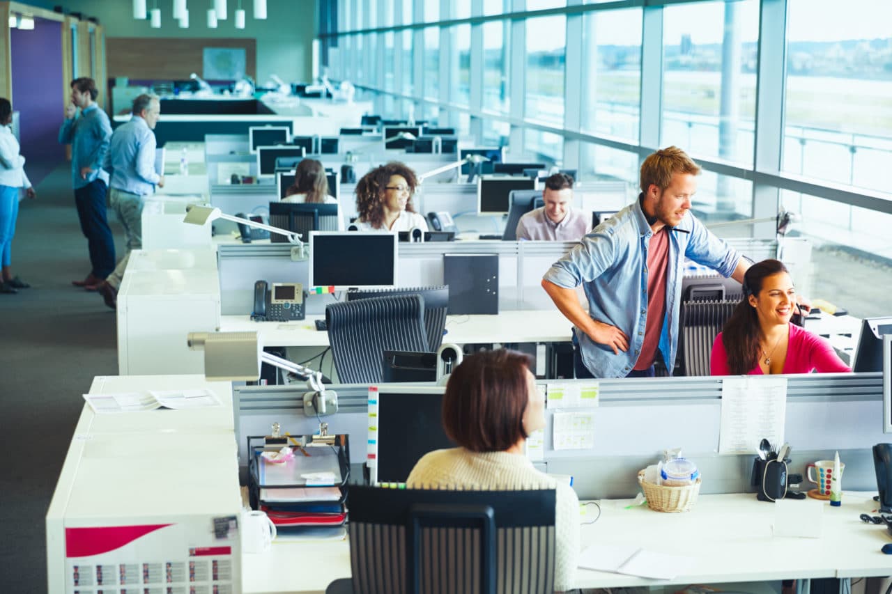 Call center story 1 employees in office with desks and comupters