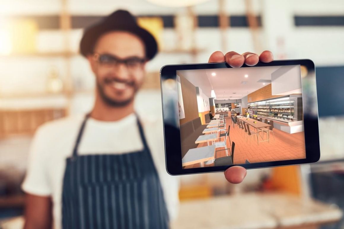 a man holding an ipad