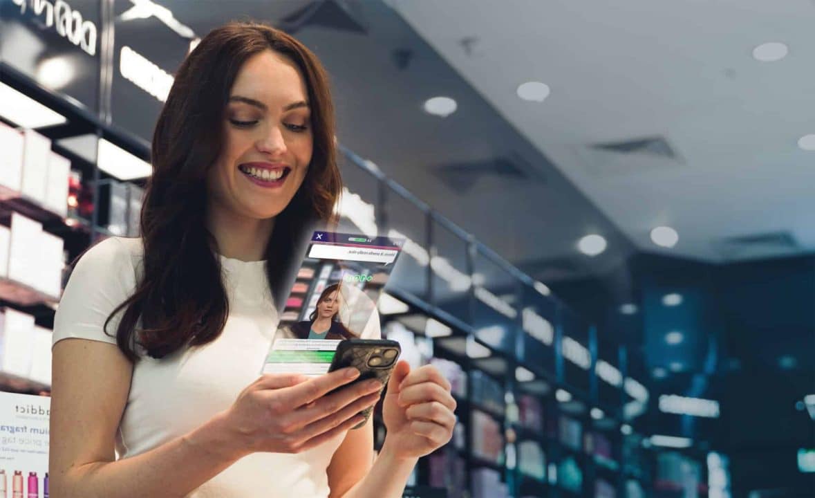 the fragrance shop employee playing attensi skills on her phone