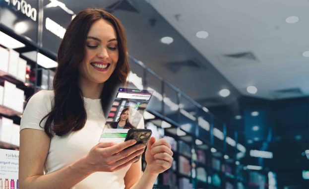 the fragrance shop employee playing attensi skills on her phone