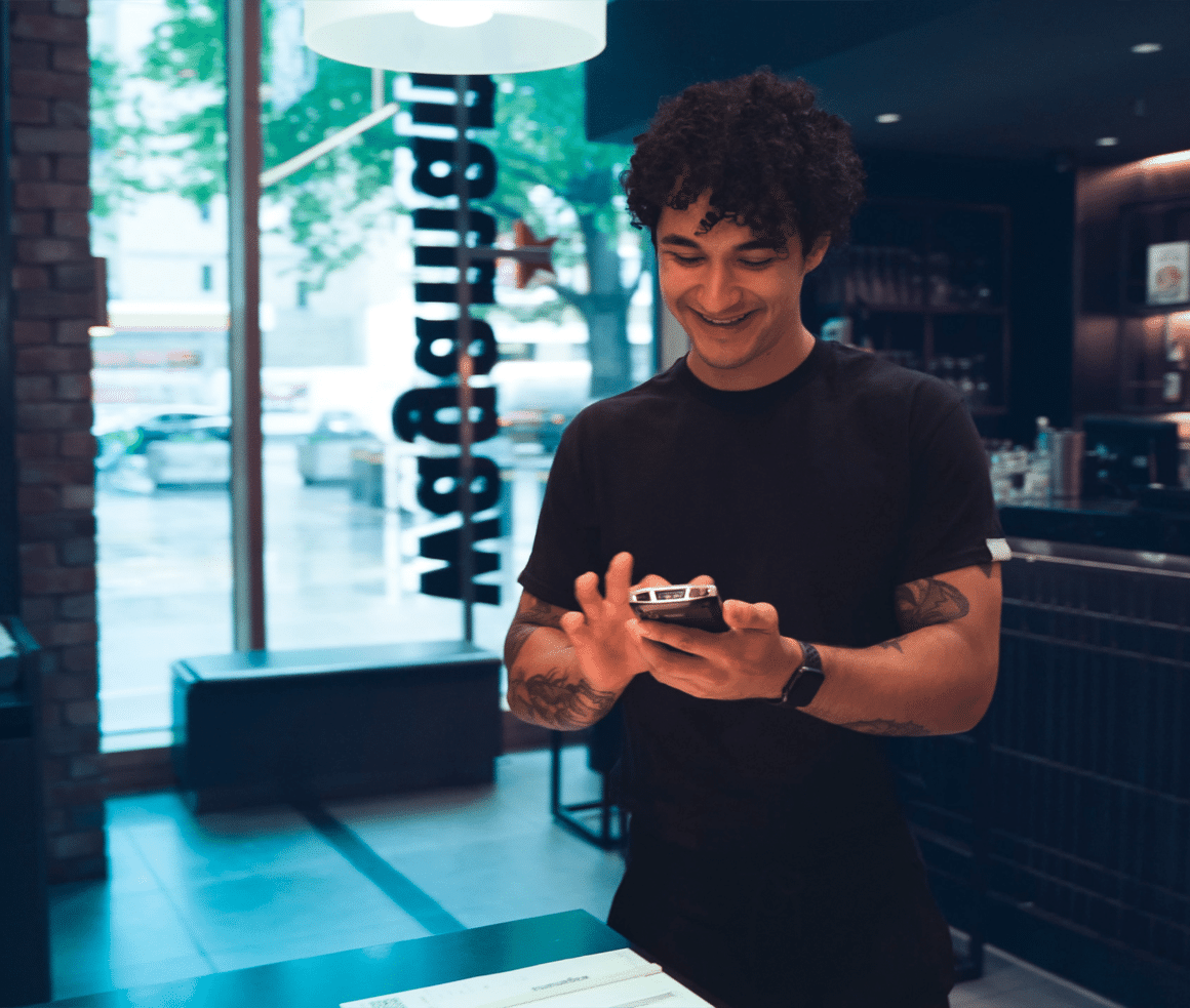 attensi franchise training a man holding a mobile phone